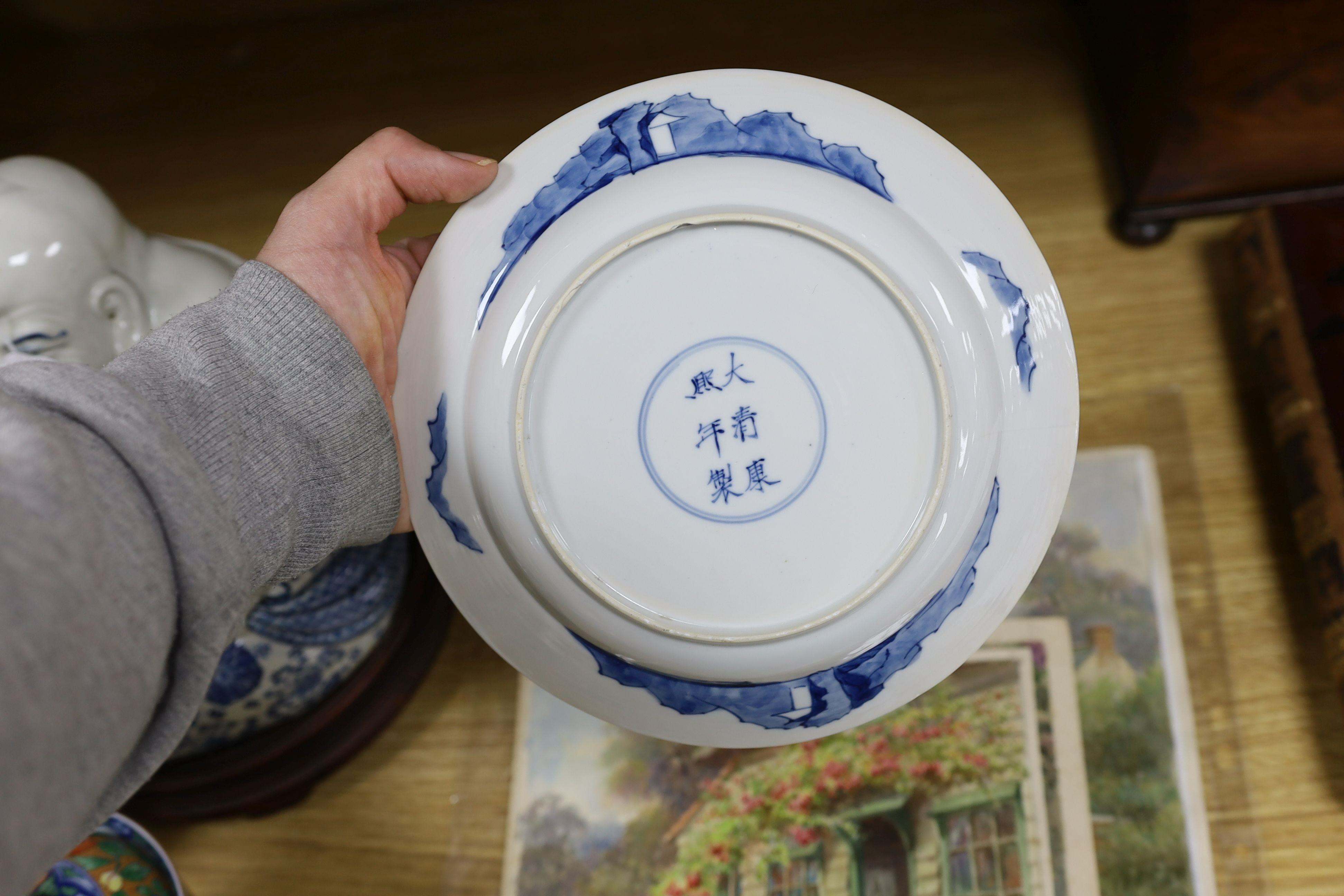 Two Chinese blue and white plates, Kangxi period, one with Kangxi mark the other a Chenghua mark, 21 cms diameter